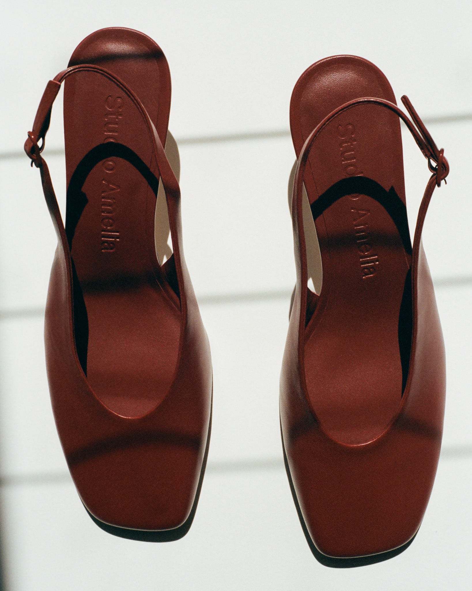 Pair of Studio Amelia maroon coloured leather pumps