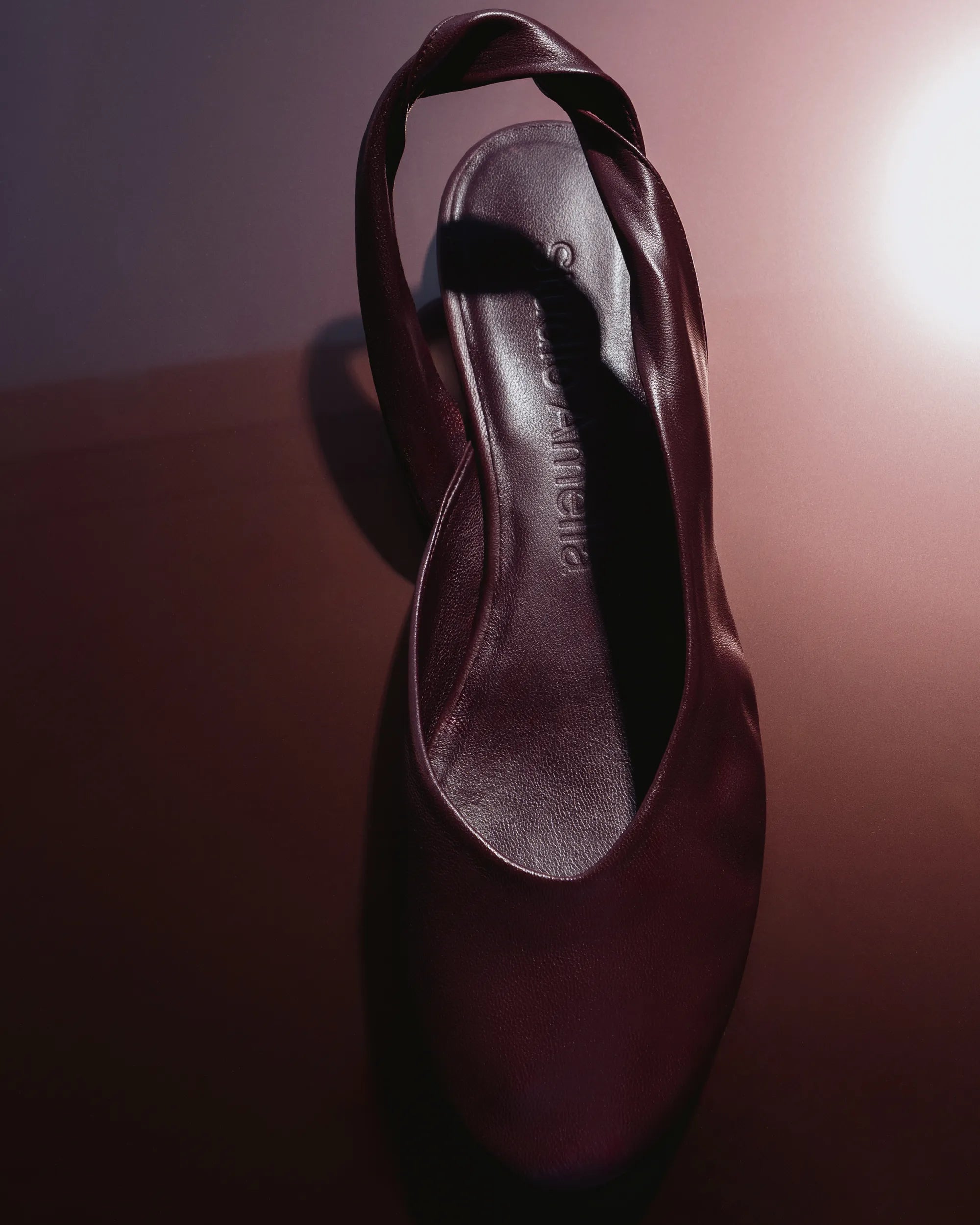 A dark burgundy ballet flat made from leather