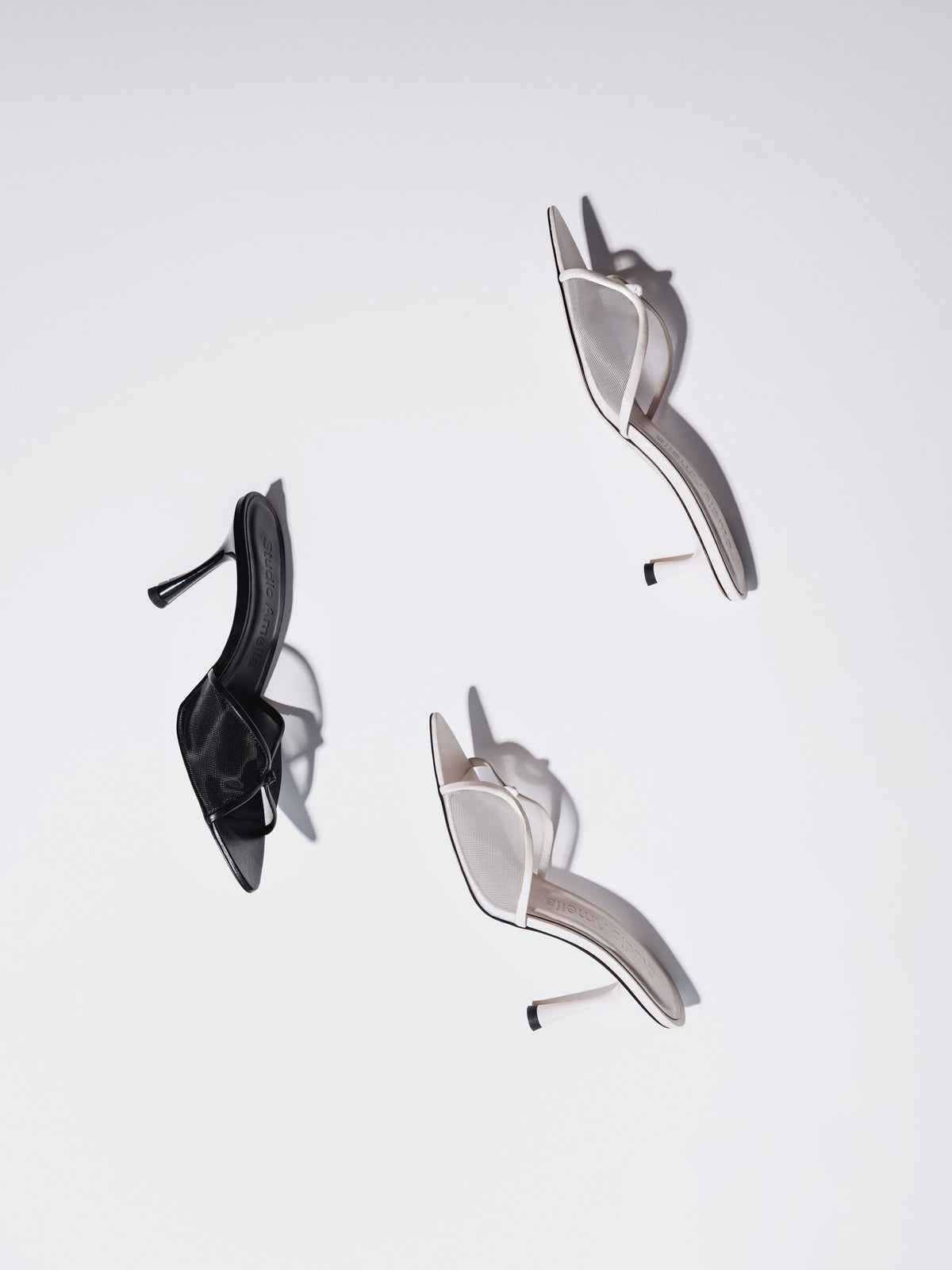 Black and white pointed sandals with a kitten and high heel