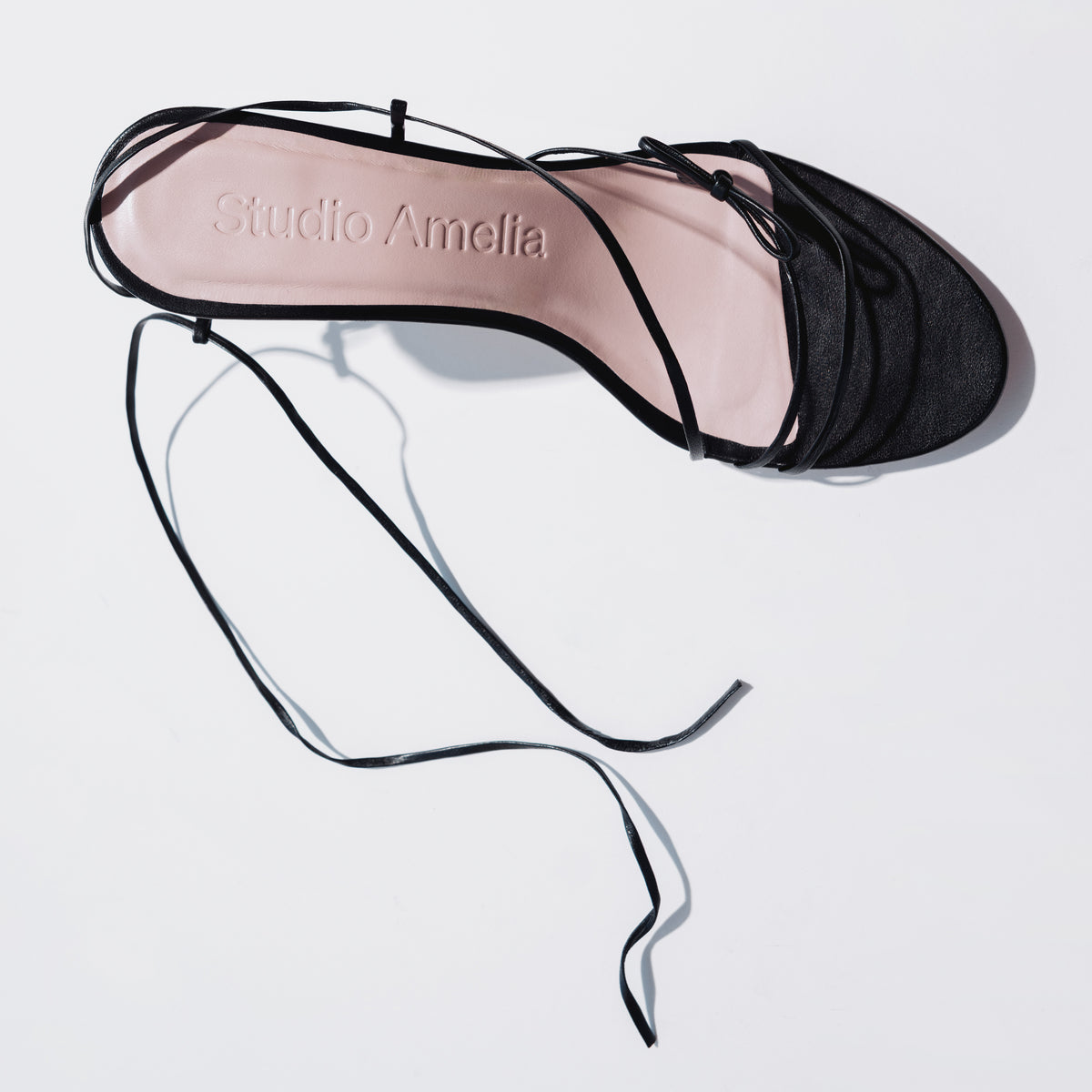 Black strappy sandals with thin leather straps made by Studio Amelia