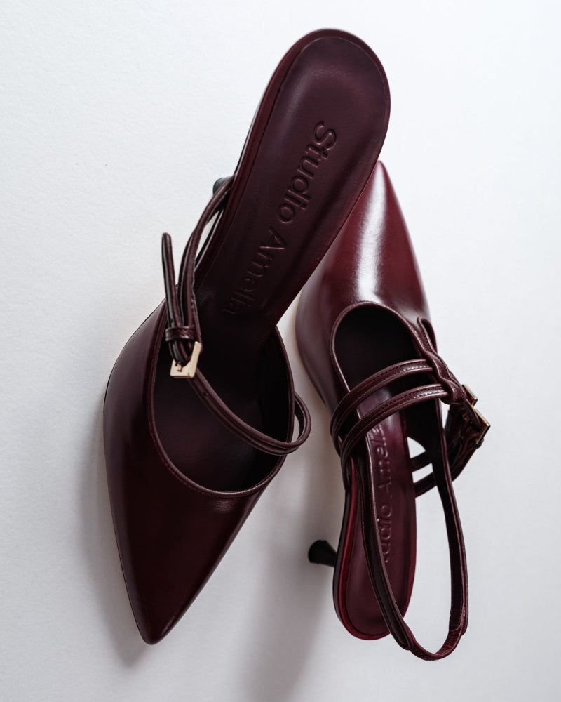 A pair of burgundy sandals with high heels