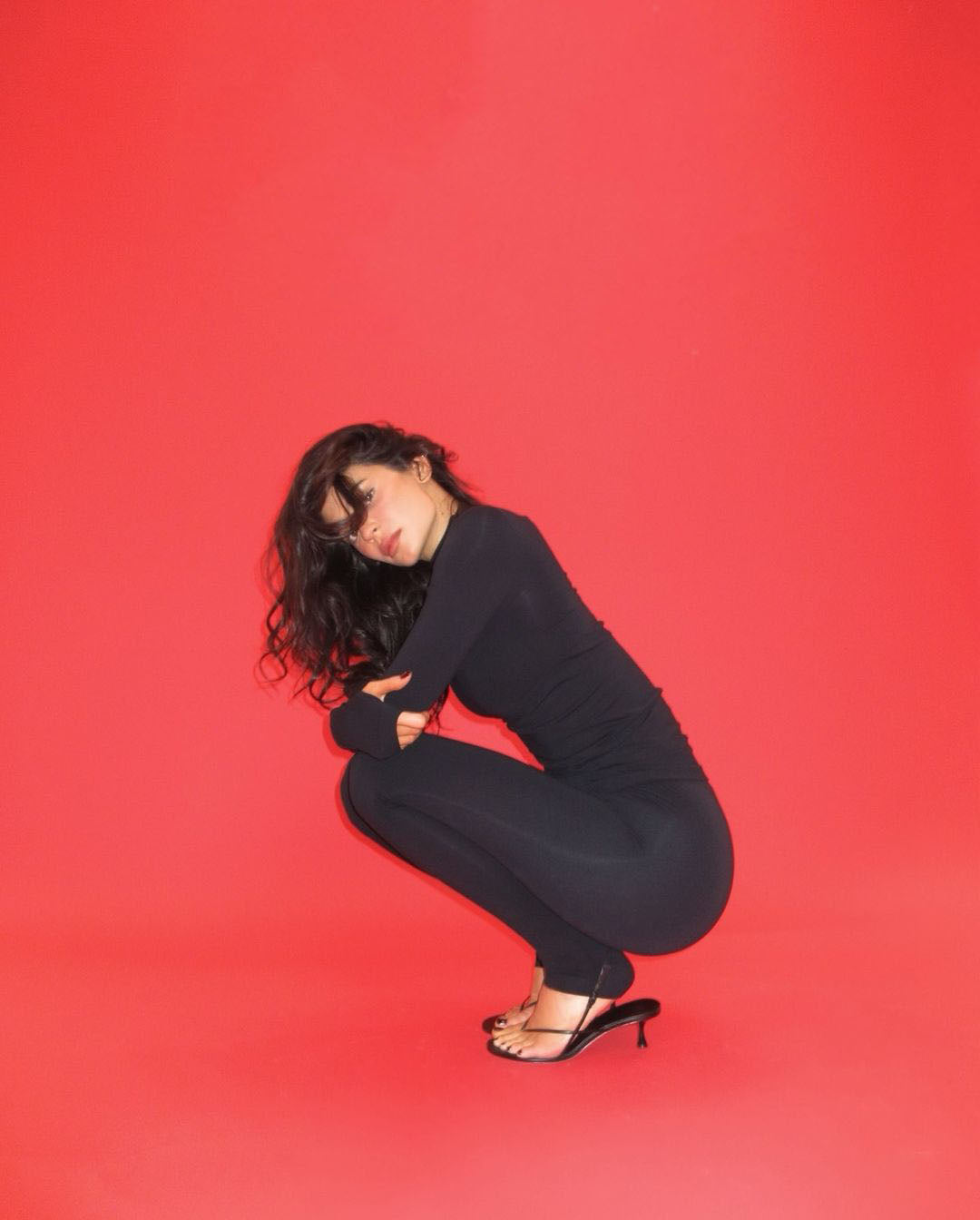 Kylie Jenner wearing the black Wishbone 50 Sandal by Studio Amelia