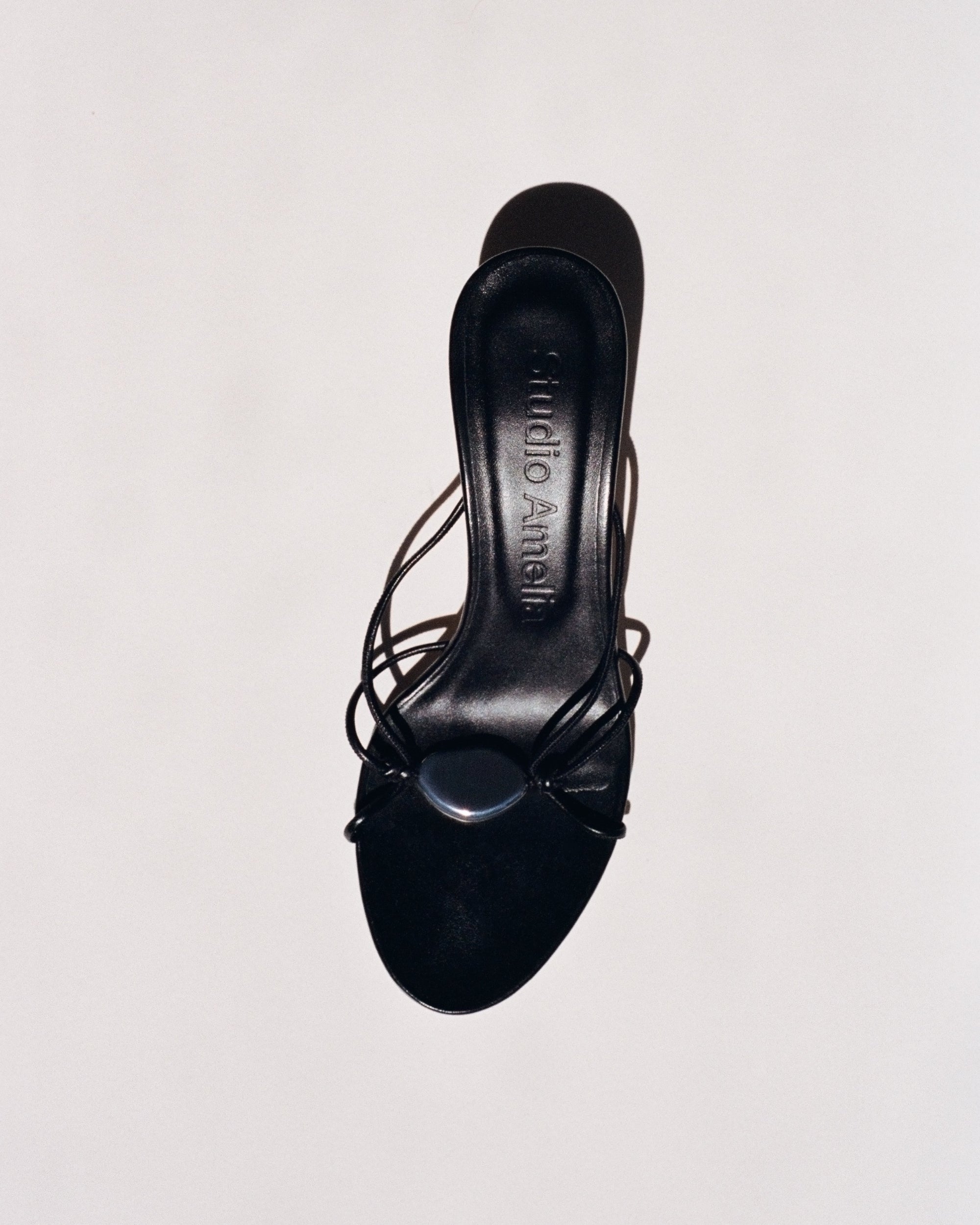 A black leather sandal with a kitten heel by Studio Amelia