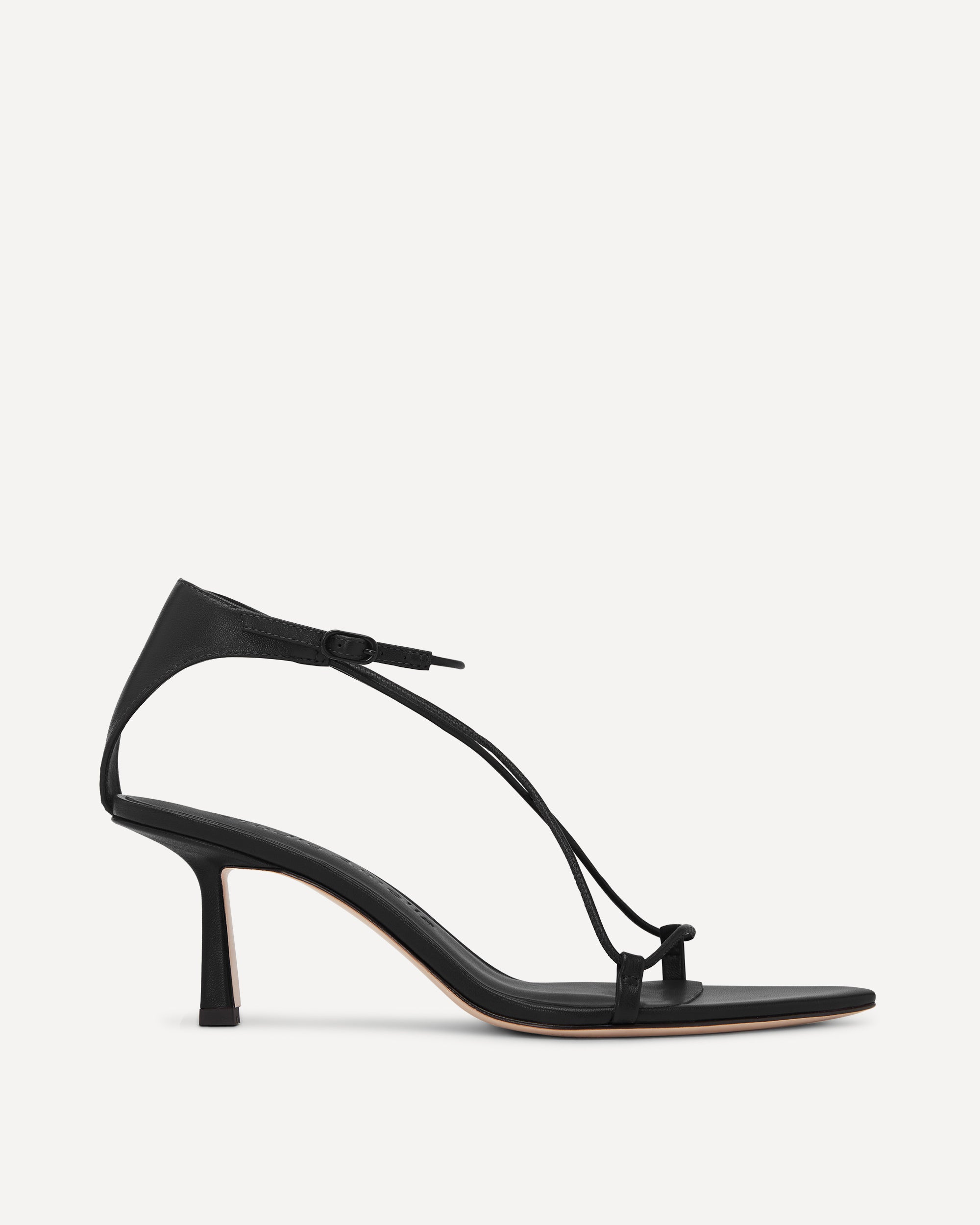 Black sandal with thin straps on a white background