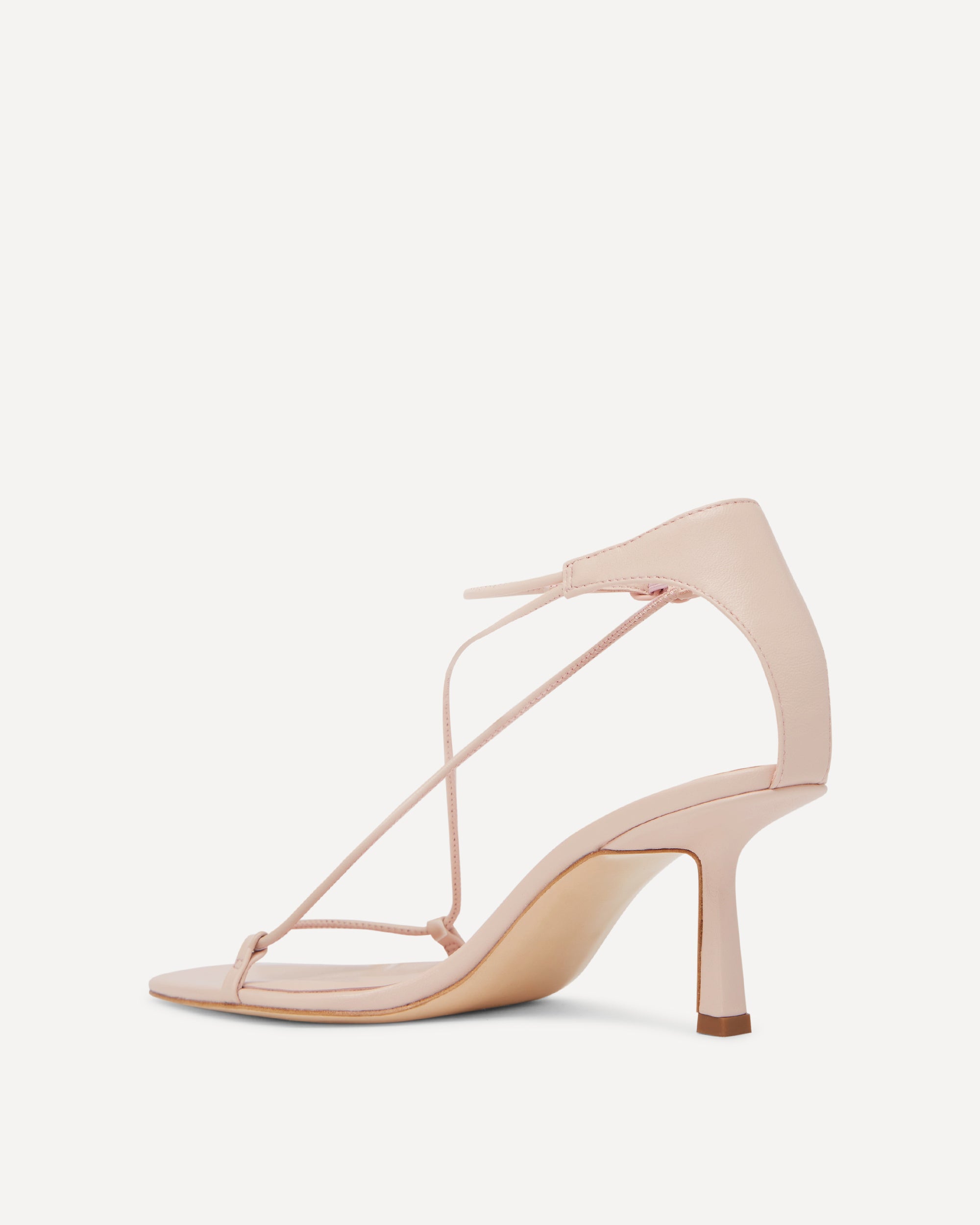 Pink-coloured sandal with thin straps on a white background