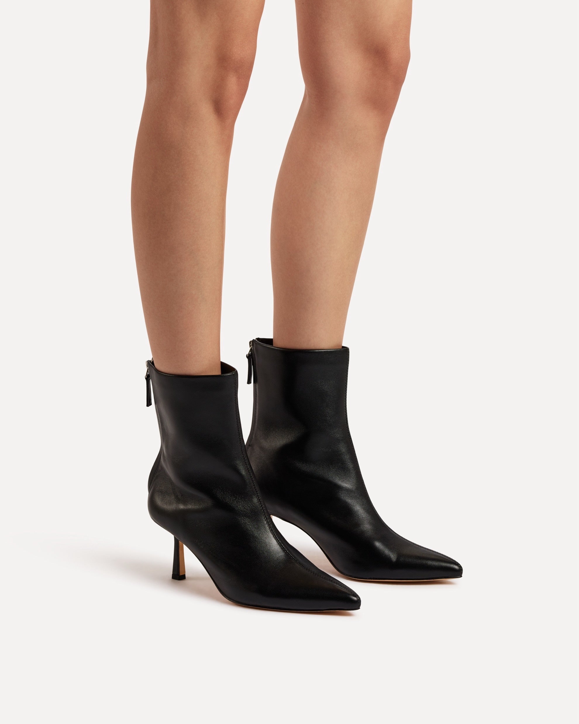 A black leather boot with heel