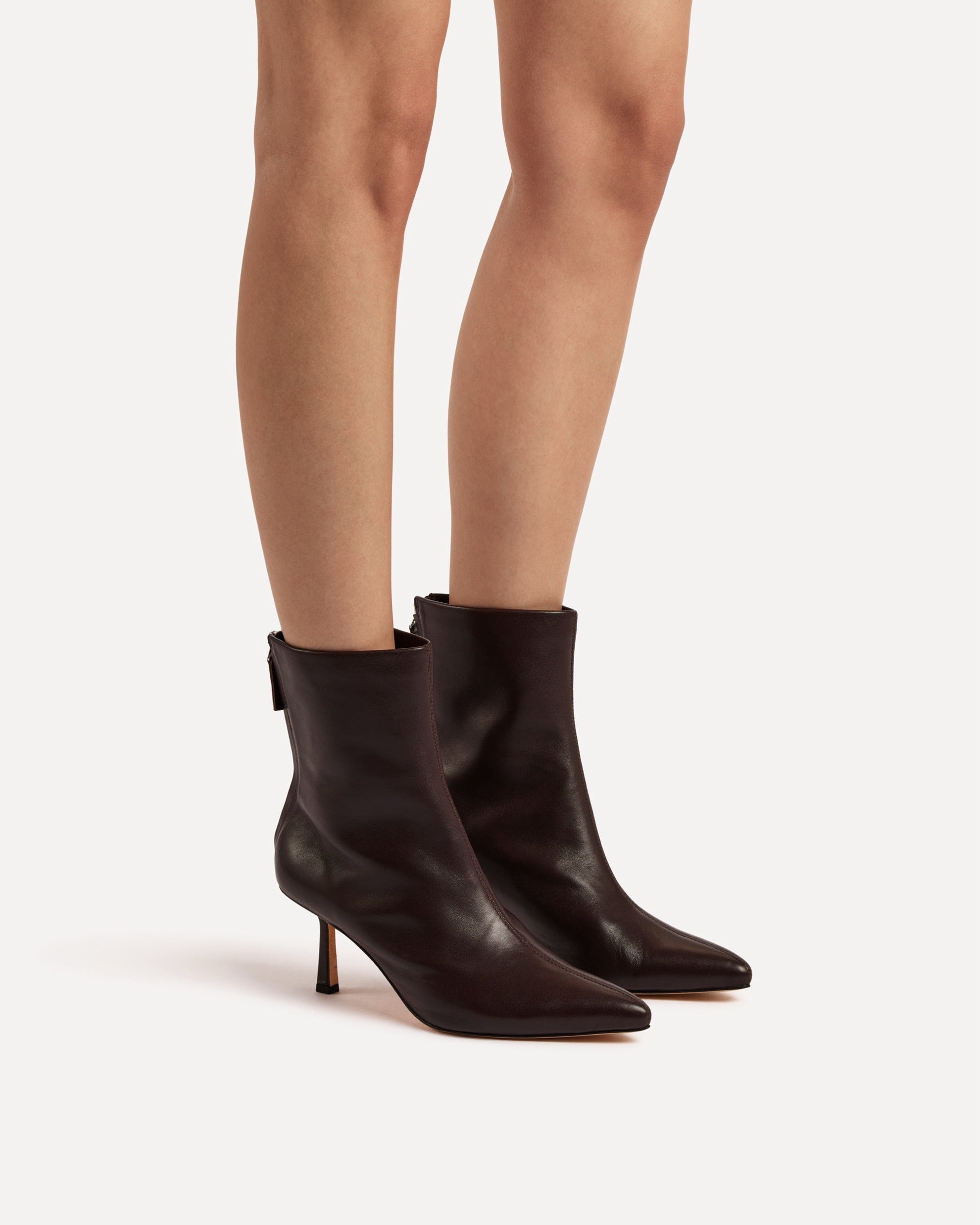 A dark brown leather boot with heel